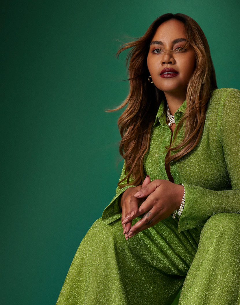 Jessica Mauboy in a green dress against a green backdrop